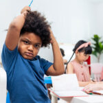 Stressed Black Child In A Classroom