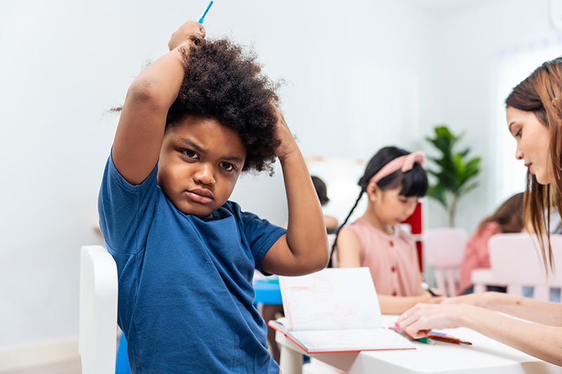 Stressed Black Child In A Classroom